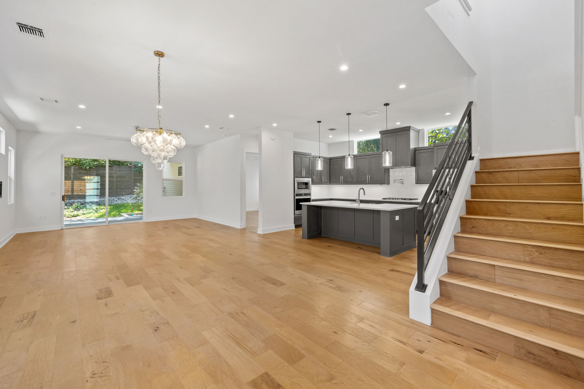 1719 Bunche Road Austin, TX 78721 - Photo 6 of 36 Warm hardwood floors flow through this light-filled open layout with a modern kitchen.