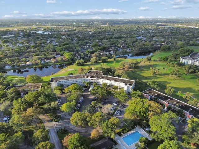 an aerial view of a residential houses with outdoor space and street view