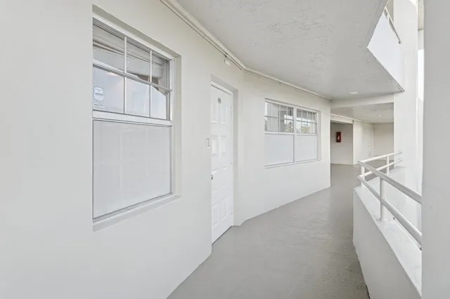 a view of a hallway with wooden floor and entryway