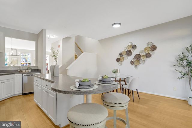 a kitchen with a table and chairs