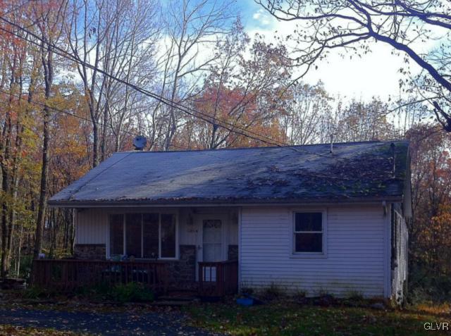 a view of brick house with a large tree
