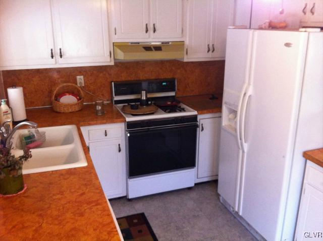 508 Westbrook Road Effort, PA 18330 - Photo 3 of 49 a kitchen with a stove top oven and refrigerator