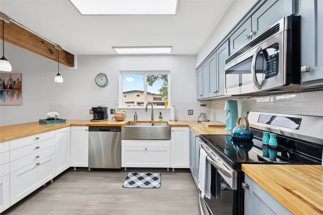 a kitchen with cabinets and window