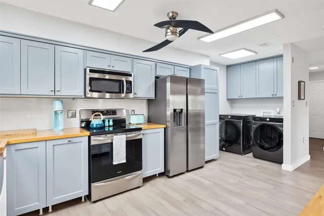a kitchen with stainless steel appliances a refrigerator stove and sink