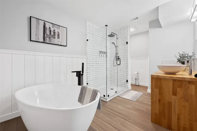 a white bath tub sitting next to a bathroom