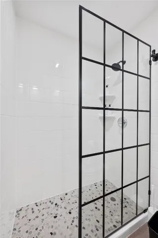 a bathroom with a glass shower door