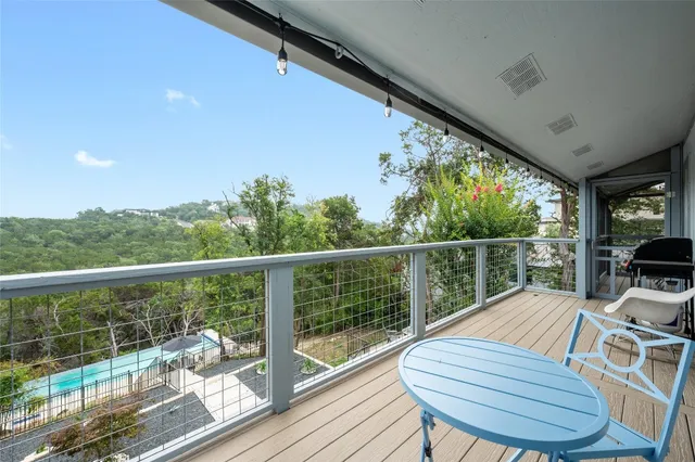 a view of a balcony with wooden floor