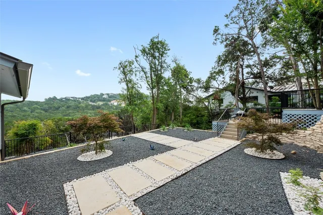 a view of a patio with table and chairs and floor to ceiling window