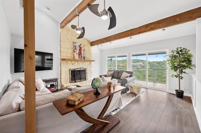 a living room with furniture fireplace and flat screen tv