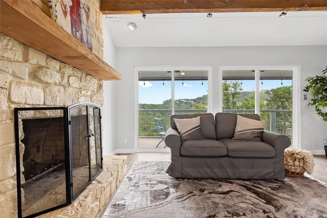 a living room with furniture and a floor to ceiling window