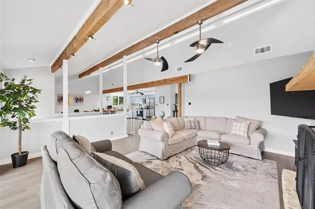 a living room with furniture and flowers