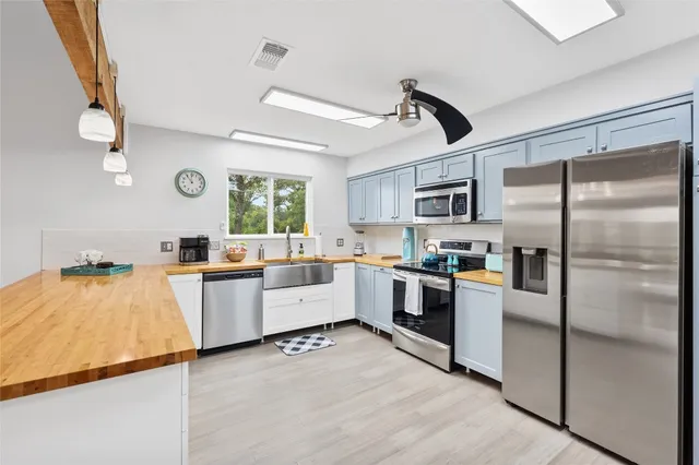 a large kitchen with cabinets and stainless steel appliances