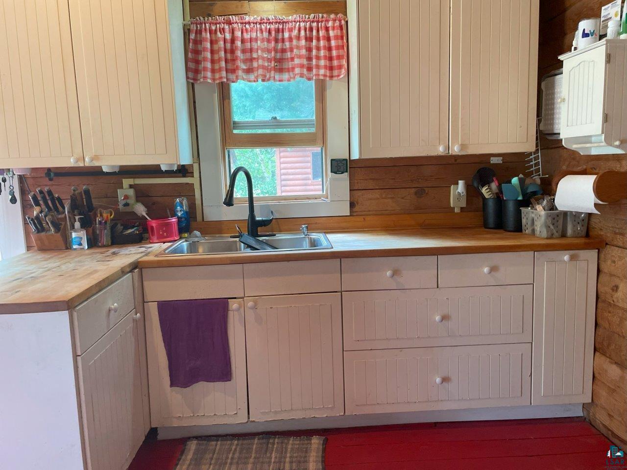 3420 Dewees Road Babbitt, MN 55706 - Photo 22 of 58 Kitchen with white cabinetry & butcher block countertops.