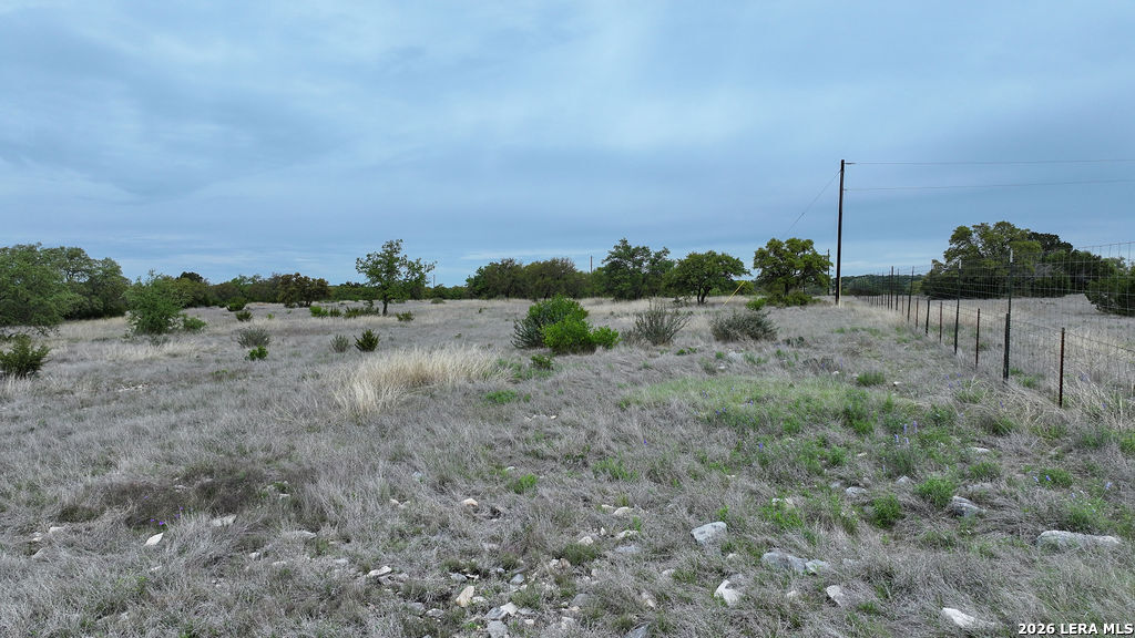684 Lester Ln Junction Junction, TX 76849 - Photo 15 of 15 a view of a dry yard with wooden fence