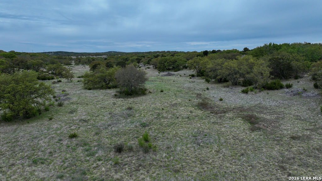 684 Lester Ln Junction Junction, TX 76849 - Photo 7 of 15 a view of a field with trees in background