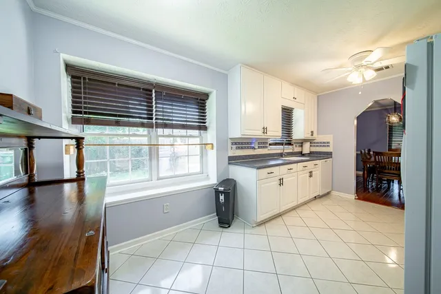 a kitchen with a stove a sink and a refrigerator