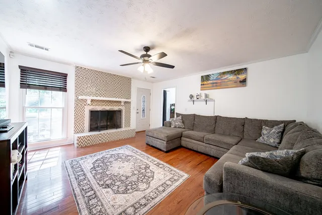 a living room with furniture and a fireplace