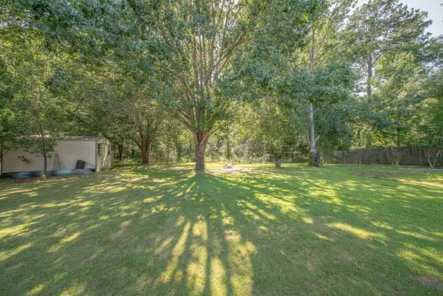 a backyard of a house with trees and a house
