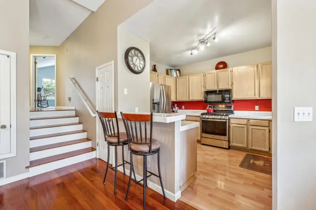 a kitchen with a table chairs and a stove top oven