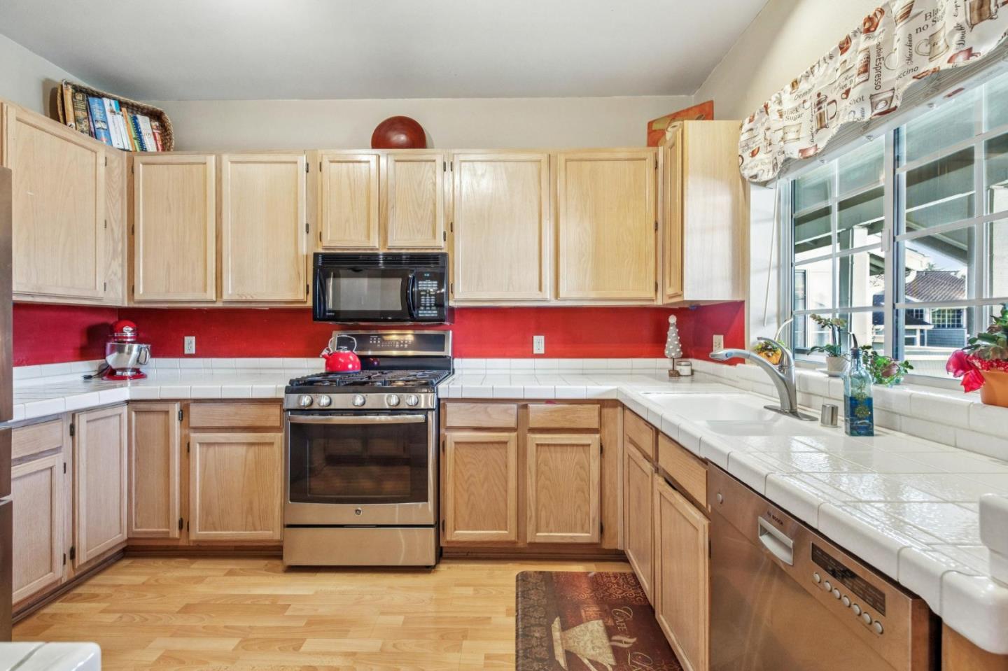 175 Troon Way Half Moon Bay, CA 94019 - Photo 19 of 49 a kitchen with stainless steel appliances granite countertop a sink stove and cabinets