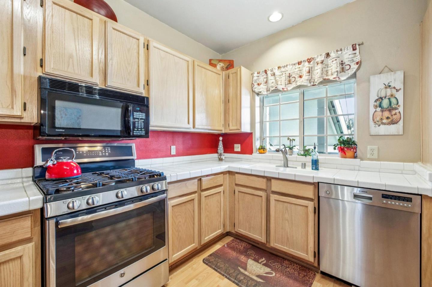 175 Troon Way Half Moon Bay, CA 94019 - Photo 21 of 49 a kitchen with stainless steel appliances a stove microwave and sink