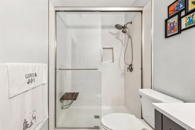 a bathroom with a toilet and a shower
