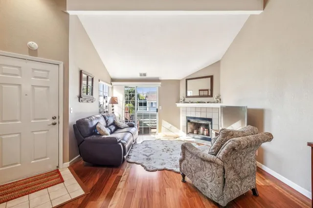 a living room with furniture and a fireplace