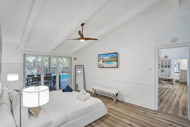 a bed sitting in a bedroom next to a window