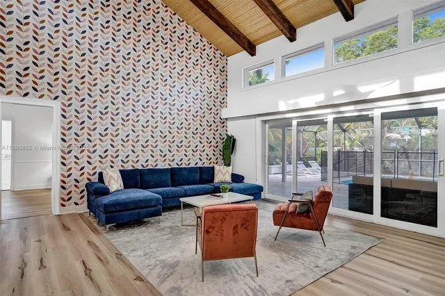a living room with fireplace furniture and a floor to ceiling window