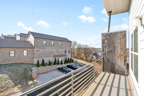 a view of a balcony with a floor to ceiling window and wooden floor