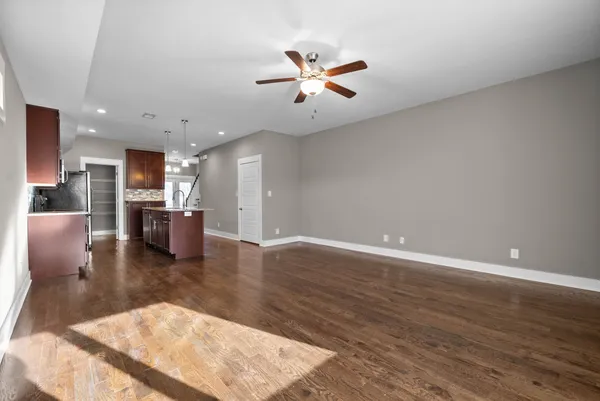 a view of a kitchen with a sink and a refrigerator