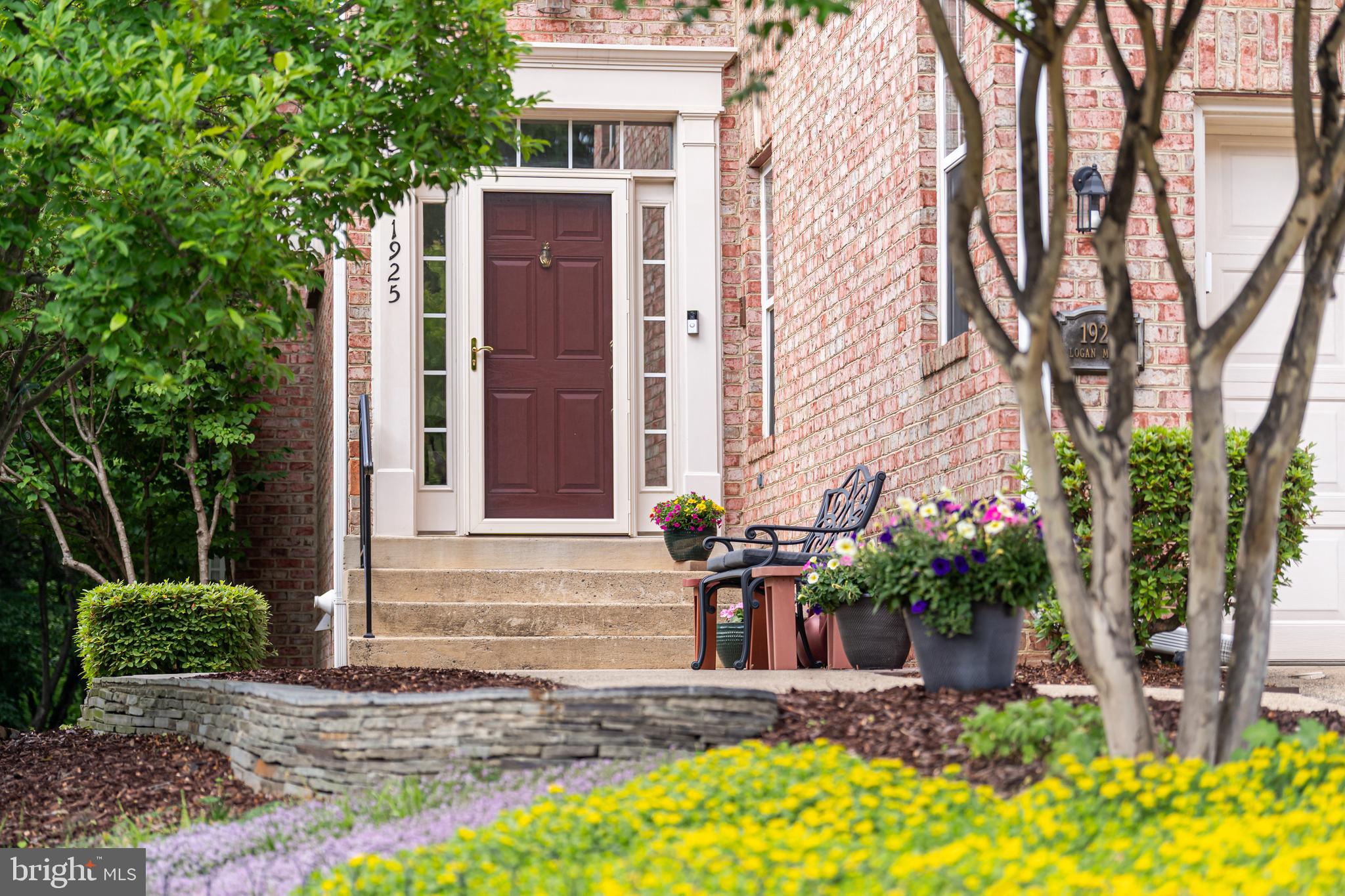 1925 Logan Manor Drive Reston, VA 20190 - Photo 5 of 61 a front view of a house with a yard