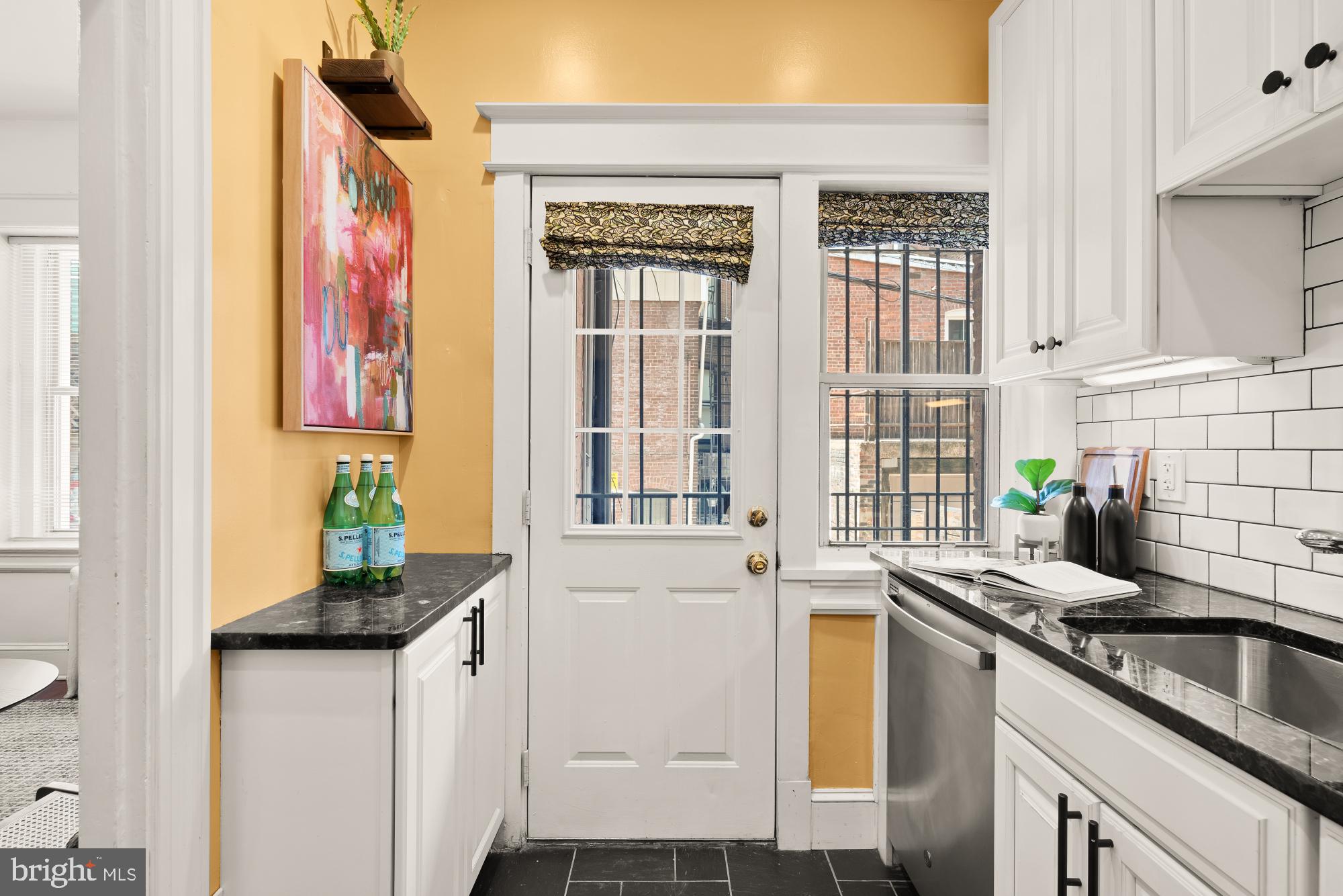 1833 S Street Northwest, Unit 2 Washington, DC 20009 - Photo 12 of 29 a kitchen with stainless steel appliances granite countertop a sink stove and cabinets