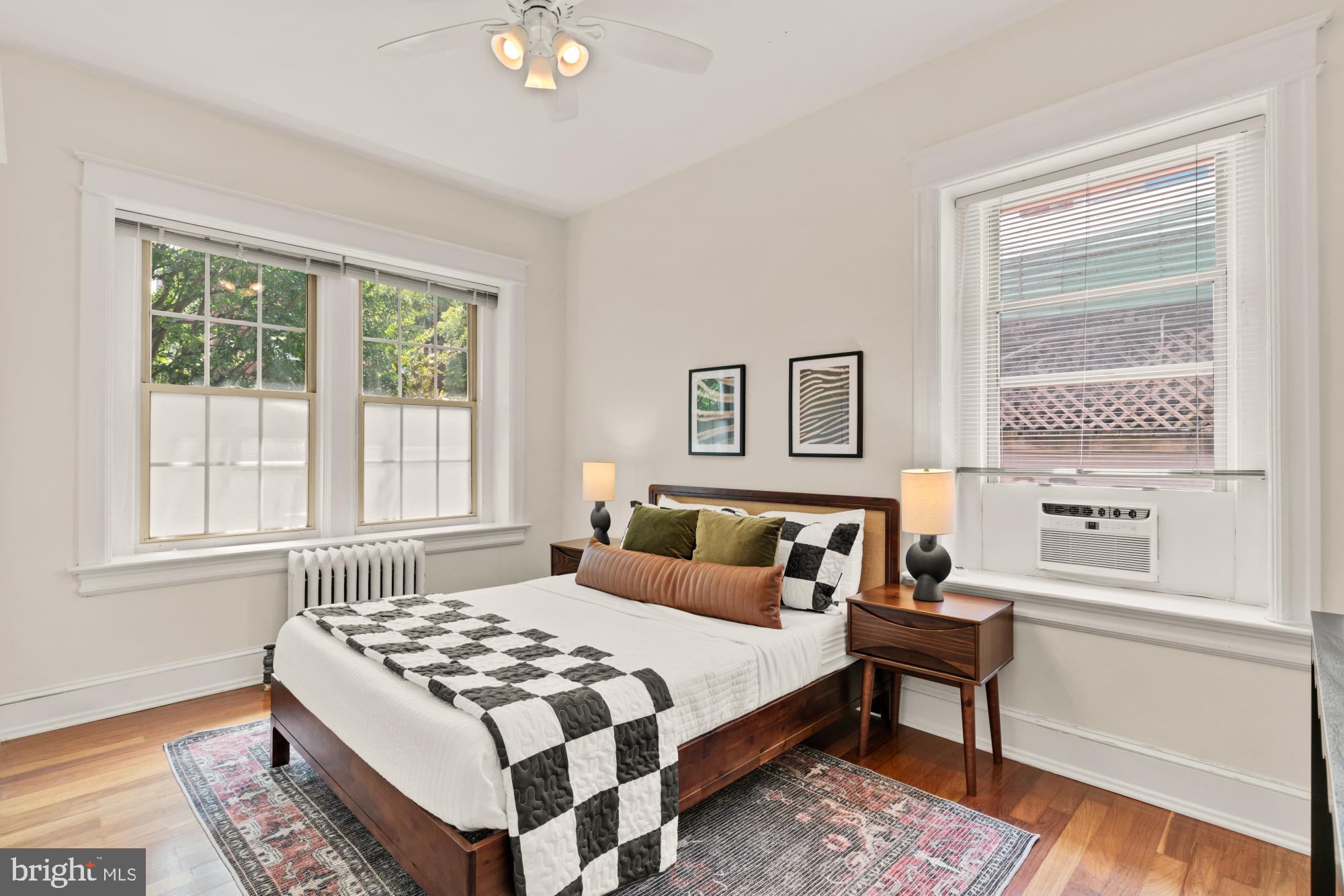 1833 S Street Northwest, Unit 2 Washington, DC 20009 - Photo 14 of 29 a bedroom with a bed lamp and a window
