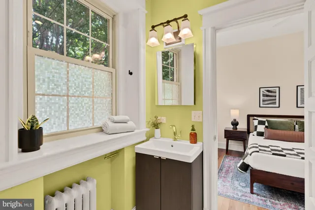 a bathroom with a granite countertop toilet sink and mirror