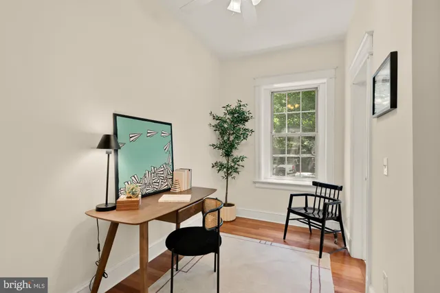 a workspace room with furniture and wooden floor