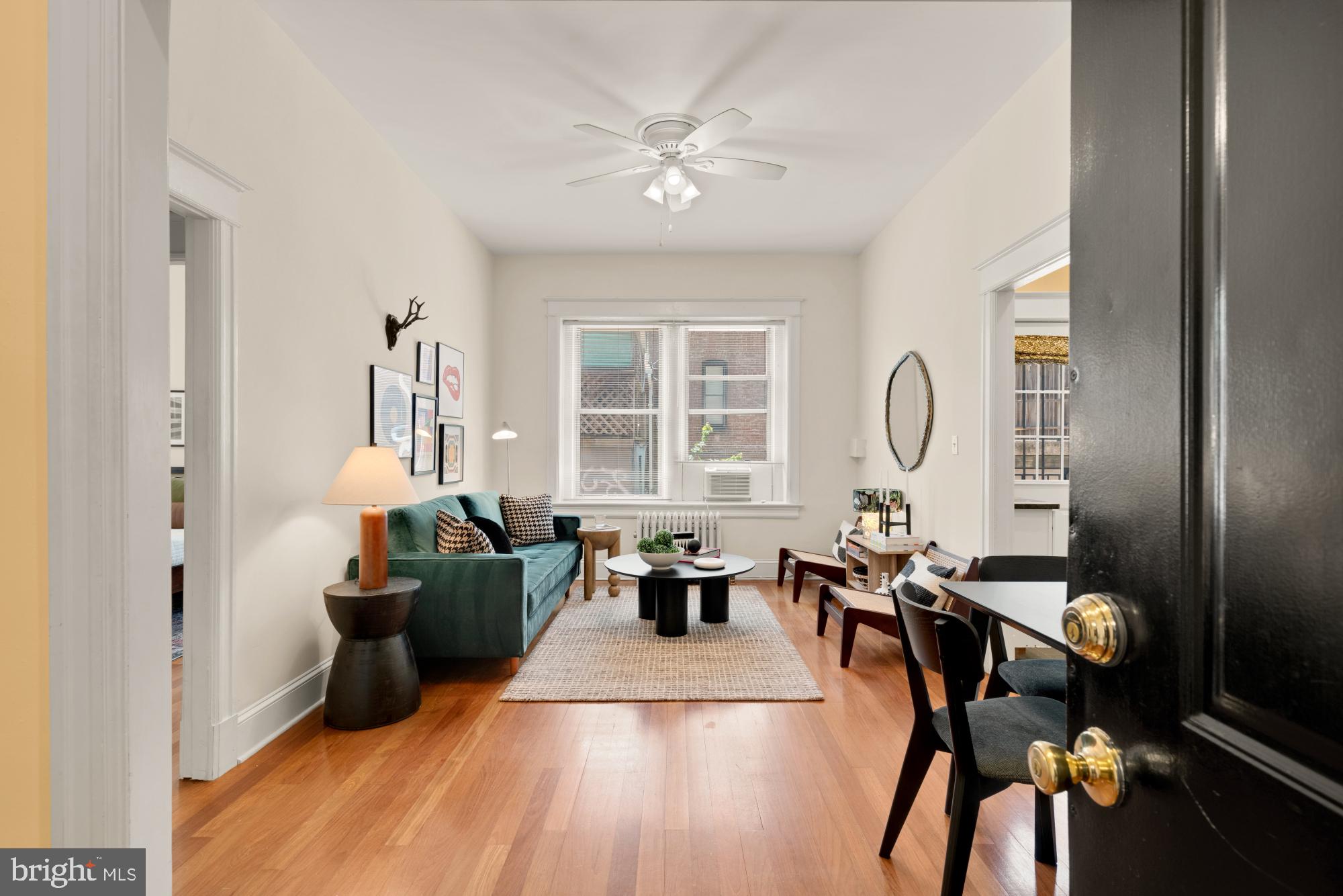 1833 S Street Northwest, Unit 2 Washington, DC 20009 - Photo 2 of 29 a living room with furniture two window and wooden floor