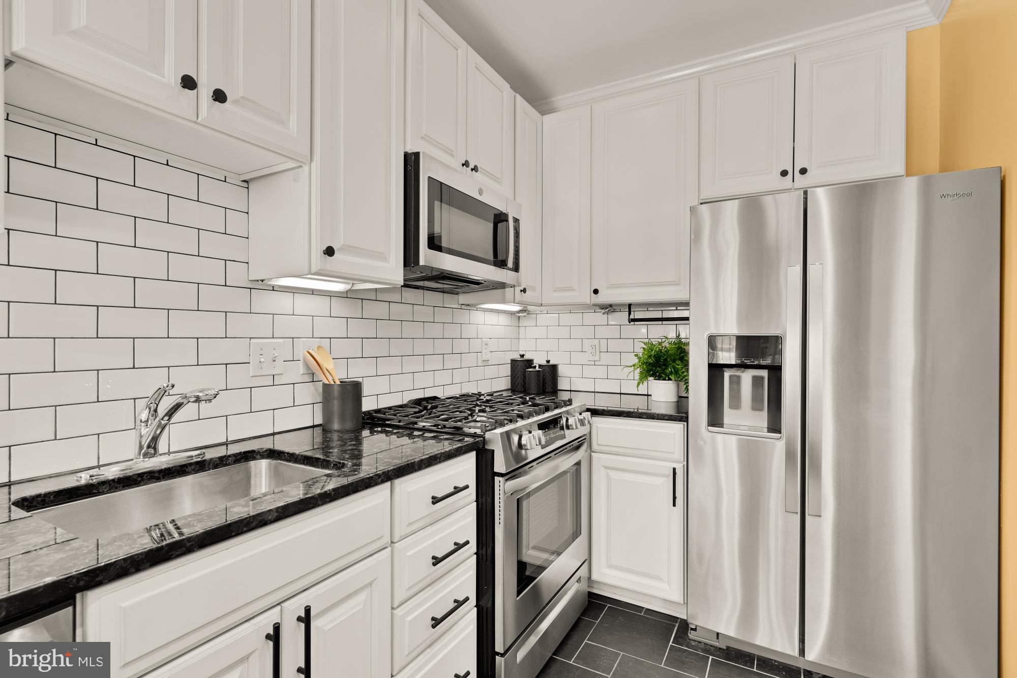 1833 S Street Northwest, Unit 2 Washington, DC 20009 - Photo 9 of 29 a kitchen with stainless steel appliances white cabinets and a stove