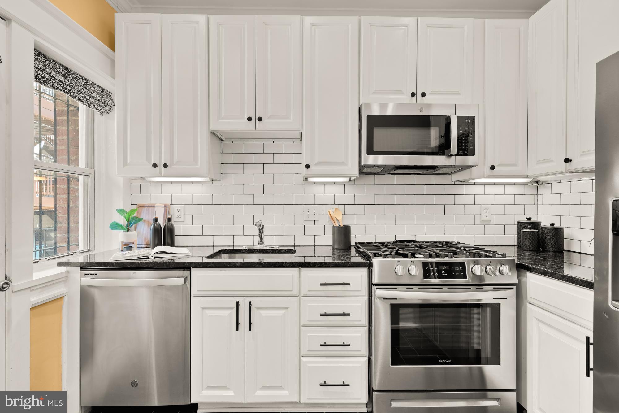 1833 S Street Northwest, Unit 2 Washington, DC 20009 - Photo 10 of 29 a kitchen with white cabinets and appliances