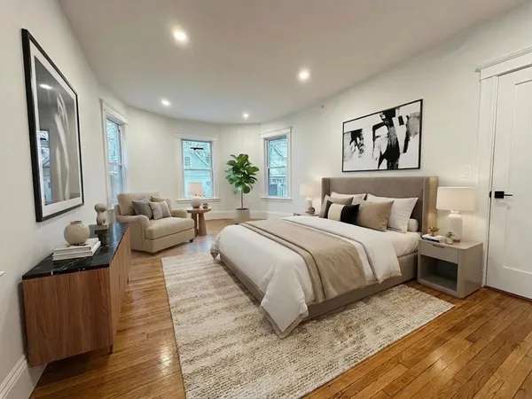 a bedroom with a large bed and furniture