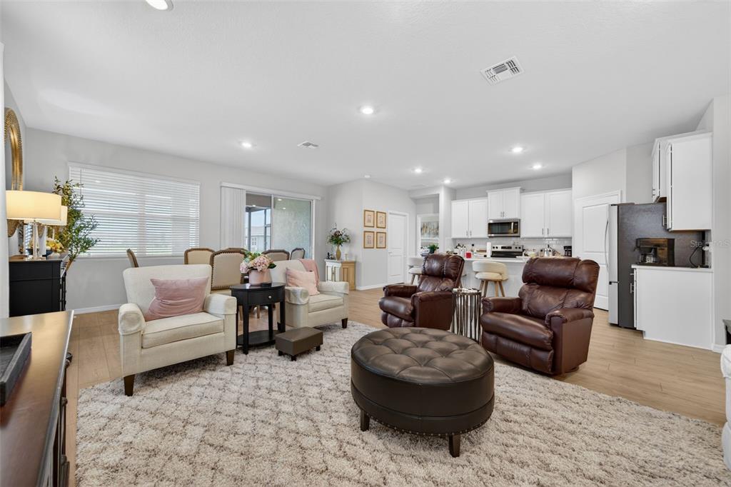 18237 Beach Ranch Terrace Bradenton, FL 34211 - Photo 33 of 72 a living room with furniture and a view of kitchen
