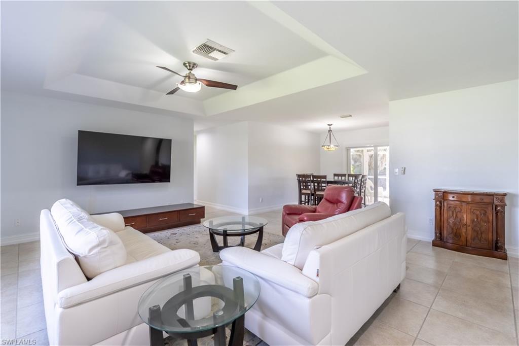 2100 55th Street Southwest Naples, FL 34116 - Photo 20 of 50 a living room with furniture and a flat screen tv