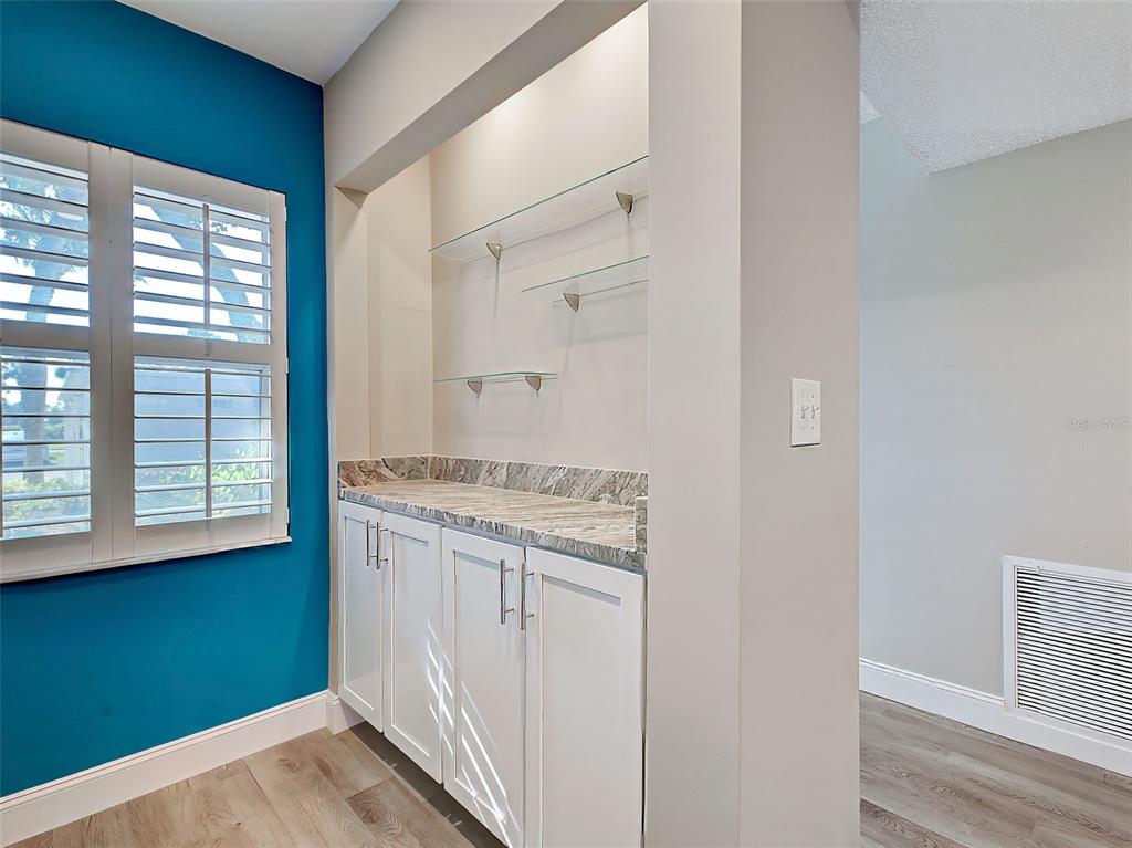 429 Cerromar Lane, Unit 352 Venice, FL 34293 - Photo 13 of 47 a view of a kitchen with wooden floor and staircase