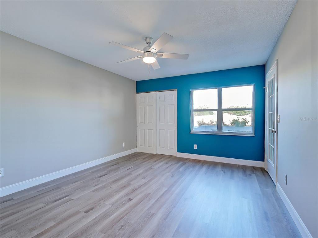 429 Cerromar Lane, Unit 352 Venice, FL 34293 - Photo 16 of 47 a view of an empty room with window and wooden floor