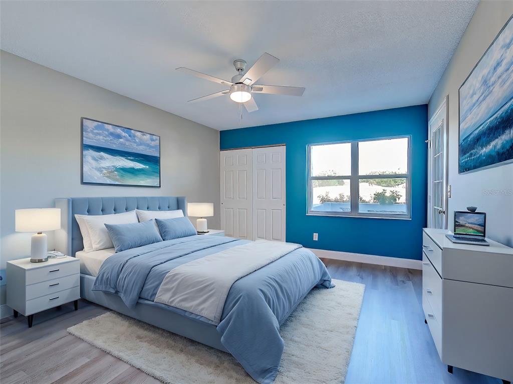 429 Cerromar Lane, Unit 352 Venice, FL 34293 - Photo 17 of 47 a bedroom with a large bed cabinet and a window