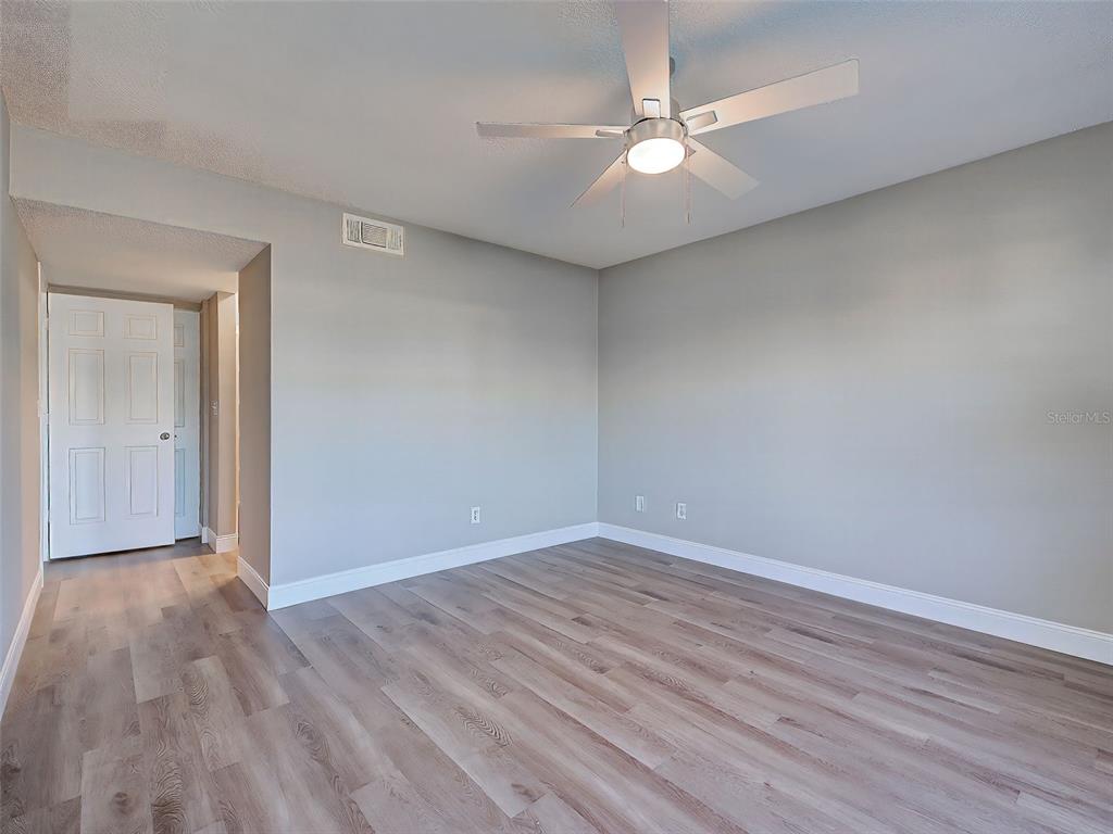 429 Cerromar Lane, Unit 352 Venice, FL 34293 - Photo 19 of 47 a view of an empty room with wooden floor