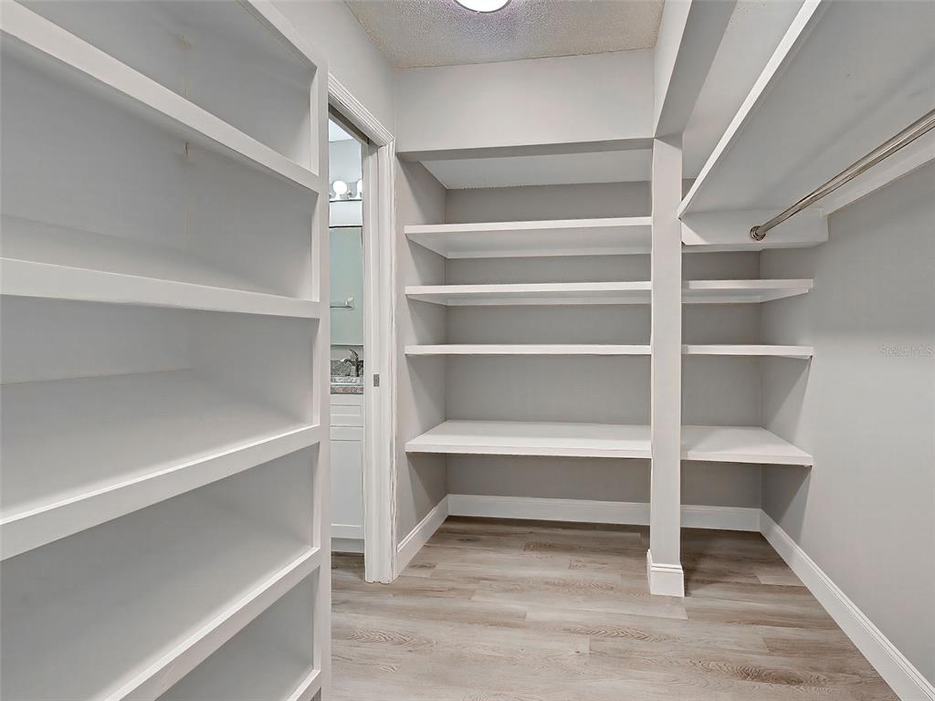 429 Cerromar Lane, Unit 352 Venice, FL 34293 - Photo 23 of 47 a view of walk in closet with empty racks