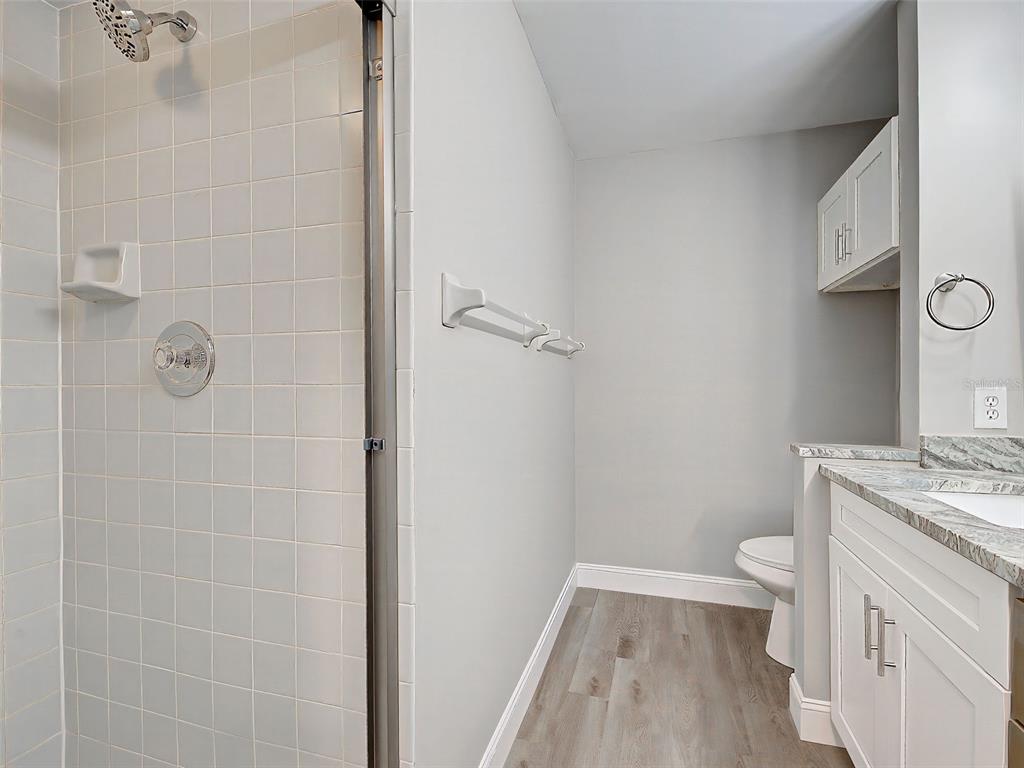 429 Cerromar Lane, Unit 352 Venice, FL 34293 - Photo 26 of 47 a bathroom with a granite countertop sink toilet and shower