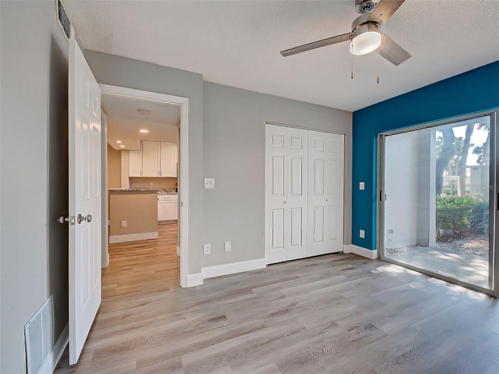 429 Cerromar Lane, Unit 352 Venice, FL 34293 - Photo 28 of 47 a view of a hallway with wooden floor and a ceiling fan