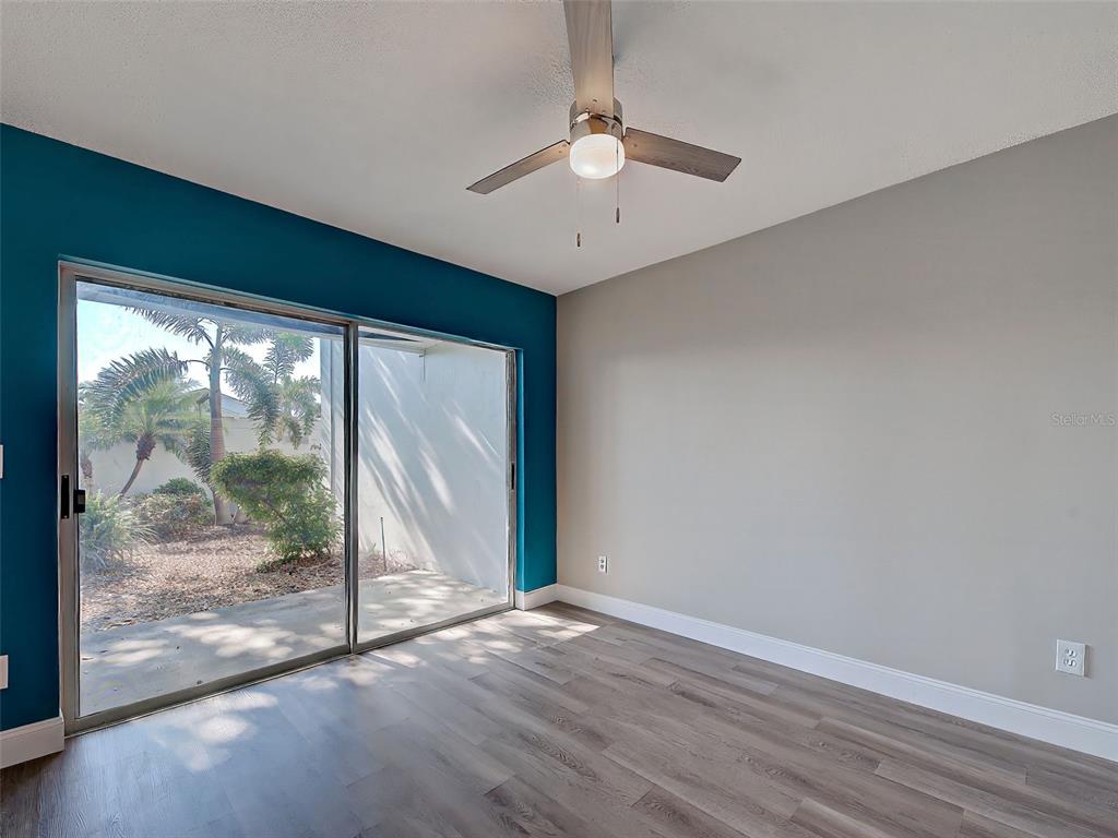 429 Cerromar Lane, Unit 352 Venice, FL 34293 - Photo 31 of 47 an empty room with wooden floor and outdoor view